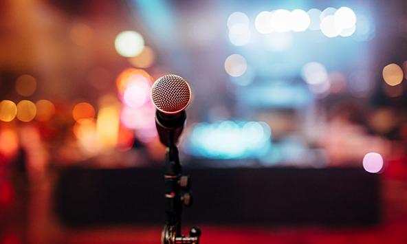 microphone on a stage with blurry lights behind it